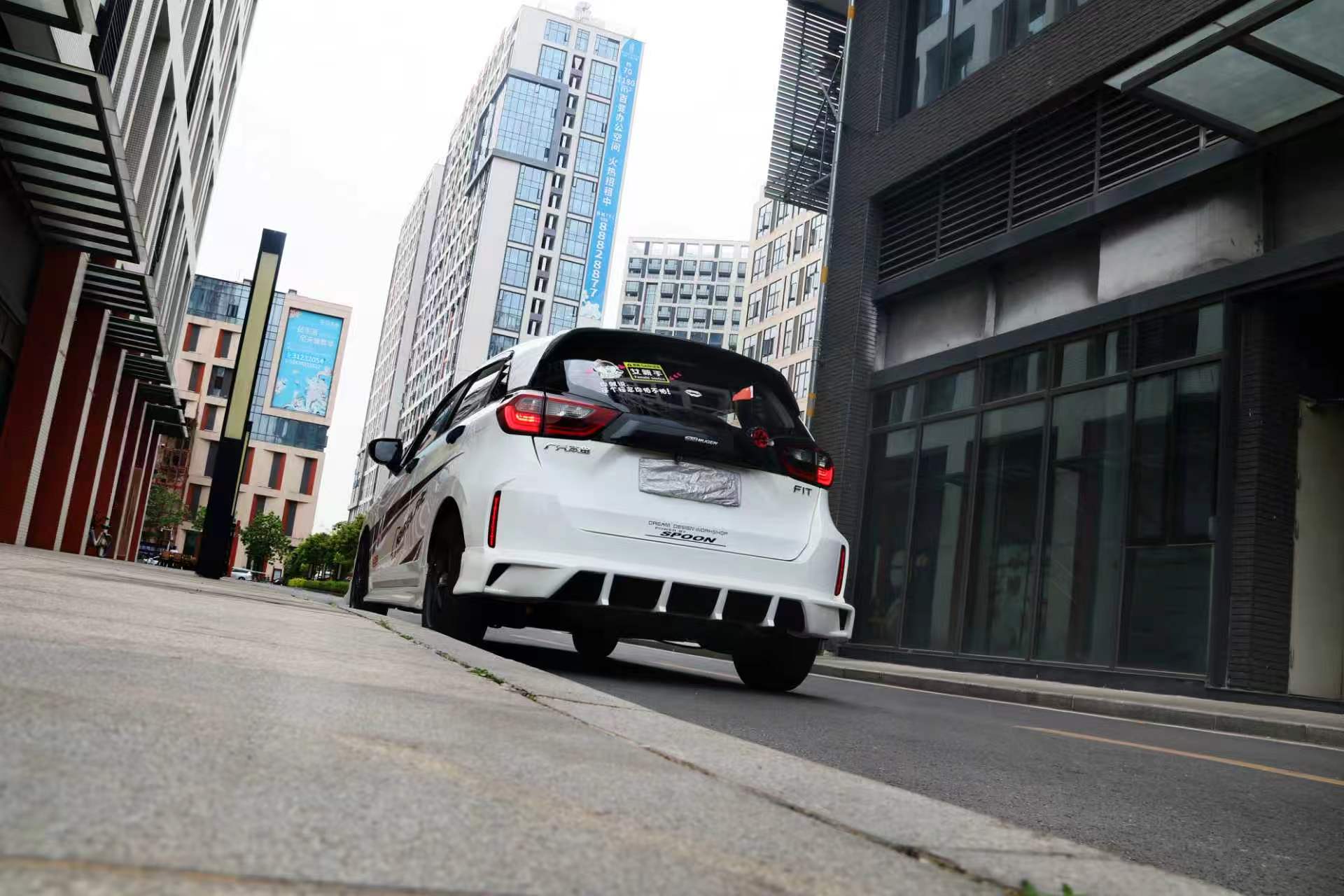 Rear diffuser styling on a white Honda Fit